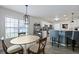 View of the kitchen and breakfast bar area with modern pendant lighting at 177 Sugar Magnolia Way, Charleston, SC 29414