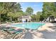 Community pool and lounge area surrounded by lush greenery, ideal for relaxation and recreation at 177 Sugar Magnolia Way, Charleston, SC 29414