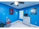 Fun blue bedroom with colorful decor and a large window for natural light at 1865 Towne St, Johns Island, SC 29455