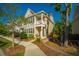 Inviting two-story townhome with manicured front yard, charming porch, and lush landscaping at 1865 Towne St, Johns Island, SC 29455