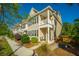 Charming two-story townhome with tan siding, a quaint porch, and a well-maintained front yard at 1865 Towne St, Johns Island, SC 29455