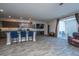 Open-concept living room featuring a kitchen island with seating and sliding glass doors to the patio at 1865 Towne St, Johns Island, SC 29455