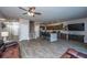 Spacious living room with wood floors, kitchen with island, and staircase with safety gate at 1865 Towne St, Johns Island, SC 29455