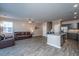 Open living space with wood floors, a modern kitchen, and a comfortable leather sofa at 1865 Towne St, Johns Island, SC 29455