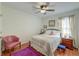 Cozy bedroom featuring a comfortable bed, a ceiling fan, and a bright window at 1929 Treebark Dr, Charleston, SC 29414
