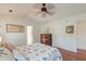 A bedroom with a ceiling fan, wood floors, a decorative quilt, and plenty of natural light at 1929 Treebark Dr, Charleston, SC 29414