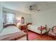 Charming bedroom featuring twin beds, floral curtains, and ceiling fan at 1929 Treebark Dr, Charleston, SC 29414