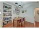 Bright dining area with a modern light fixture, built-in shelving, and an accent wall with decorative artwork at 1929 Treebark Dr, Charleston, SC 29414