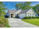 Well-maintained home with a spacious driveway, attached garage, and manicured landscaping at 1929 Treebark Dr, Charleston, SC 29414