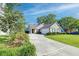 Charming single-story home featuring a manicured lawn and a spacious driveway leading to an attached garage at 1929 Treebark Dr, Charleston, SC 29414