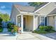 Inviting front porch with seating area and view of the front yard and walkway to the front door at 1929 Treebark Dr, Charleston, SC 29414