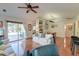 Open living space connecting to the dining area, with a sliding door to the pool and a ceiling fan at 1929 Treebark Dr, Charleston, SC 29414
