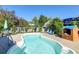 Backyard pool area with lounge chairs, a blue umbrella, and a playhouse, creating a fun and relaxing outdoor space at 1929 Treebark Dr, Charleston, SC 29414