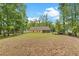 Expansive backyard with well-maintained lawn and a yellow house in the background at 1953 Suzanne St, Johns Island, SC 29455