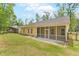 View of the back of a yellow house with a screened-in porch and fenced yard at 1953 Suzanne St, Johns Island, SC 29455