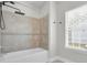 Bathtub featuring a new shower head and tiled walls at 1953 Suzanne St, Johns Island, SC 29455