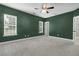 Spacious bedroom with soft carpeting, fan, and natural light from large windows at 1953 Suzanne St, Johns Island, SC 29455