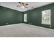 Bedroom with a ceiling fan, carpet, and windows, offering ample natural light and neutral paint at 1953 Suzanne St, Johns Island, SC 29455