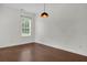 Empty bedroom featuring hardwood floors, one window, neutral paint, and modern light fixture at 1953 Suzanne St, Johns Island, SC 29455