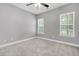 Carpeted bedroom featuring a ceiling fan and two windows at 1953 Suzanne St, Johns Island, SC 29455