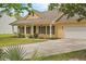 Attractive home with shutters, a well-kept lawn, front porch, and an attached garage on a bright day with curb appeal at 1953 Suzanne St, Johns Island, SC 29455
