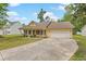 Inviting single-story home with a attached two-car garage, lush green lawn, and a quaint front porch with decorative accents at 1953 Suzanne St, Johns Island, SC 29455