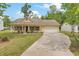Charming single-Gathering home boasts a well-manicured lawn, attached garage, and a welcoming front porch with columns at 1953 Suzanne St, Johns Island, SC 29455