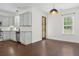 Open kitchen with granite countertops, stainless steel appliances, and backyard views via wood door at 1953 Suzanne St, Johns Island, SC 29455