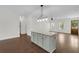 Kitchen island with granite countertop, great lighting, cabinet storage and views of the living room at 1953 Suzanne St, Johns Island, SC 29455