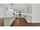 Open kitchen with stainless steel appliances, granite countertops and spacious island, ample storage, and modern lighting at 1953 Suzanne St, Johns Island, SC 29455