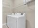 This laundry room includes shelving above a white washer and dryer at 1953 Suzanne St, Johns Island, SC 29455
