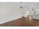 Empty living room featuring hardwood floors, neutral paint and view of the open kitchen and dining area at 1953 Suzanne St, Johns Island, SC 29455