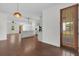 Spacious living room with a kitchen view, hardwood floors, backyard views and ceiling fan at 1953 Suzanne St, Johns Island, SC 29455