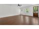 Open living room with hardwood floors, large windows, and a wooden entry door at 1953 Suzanne St, Johns Island, SC 29455