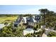 Stately home overlooking lush greenery and a golf course with a pristine driveway and manicured landscaping at 20 Old Cedar Ln, Kiawah Island, SC 29455