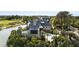 Elegant home with lush greenery and water views, featuring a pristine driveway and sophisticated landscaping at 20 Old Cedar Ln, Kiawah Island, SC 29455