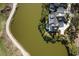 Overhead view of luxury home situated on a pond, featuring an infinity pool and patio at 20 Old Cedar Ln, Kiawah Island, SC 29455