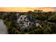 Stunning aerial view of home with pool, balcony, and lush landscaping at sunset at 20 Old Cedar Ln, Kiawah Island, SC 29455