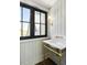 Cozy bathroom featuring brass fixtures and a picture window at 20 Old Cedar Ln, Kiawah Island, SC 29455