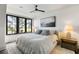 Bright bedroom with large windows, a plush bed, modern decor, and picturesque views of the water and golf course at 20 Old Cedar Ln, Kiawah Island, SC 29455