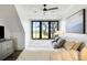 Bright bedroom with large windows, a plush bed, modern decor, and picturesque views of the water and golf course at 20 Old Cedar Ln, Kiawah Island, SC 29455