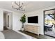 Bedroom featuring hardwood floors, a modern chandelier, and an outside deck at 20 Old Cedar Ln, Kiawah Island, SC 29455