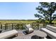 Exterior view of an outdoor deck featuring comfortable seating and picturesque views of the water and golf course at 20 Old Cedar Ln, Kiawah Island, SC 29455