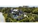 Stunning multilevel home featuring a private pool, balcony, and serene water views surrounded by lush greenery at 20 Old Cedar Ln, Kiawah Island, SC 29455