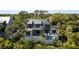 Beautiful home featuring a pool, balcony, and lush greenery, offering the ultimate in luxurious outdoor living and privacy at 20 Old Cedar Ln, Kiawah Island, SC 29455