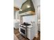 Gourmet kitchen features a professional grade range with custom hood and marble backsplash at 20 Old Cedar Ln, Kiawah Island, SC 29455