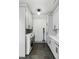 Well-equipped laundry room with sleek gray cabinets, countertop space and modern appliances at 20 Old Cedar Ln, Kiawah Island, SC 29455