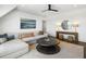 Bright living room with modern decor, featuring a large sectional sofa, contemporary art, and stylish round mirror at 20 Old Cedar Ln, Kiawah Island, SC 29455