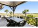 Covered patio with elegant outdoor dining set and scenic golf course views at 20 Old Cedar Ln, Kiawah Island, SC 29455