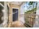 Charming balcony featuring wood flooring and a view of the surrounding trees through sheer white curtains at 200 Bucksley Ln # 302, Charleston, SC 29492